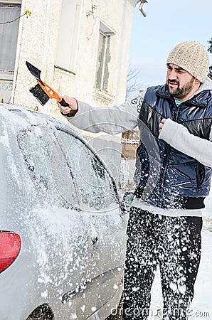 Man shovelling and removing snow Stock Photo