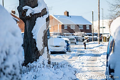 Man shovelling snow in the distance on a snowy day Stock Photo