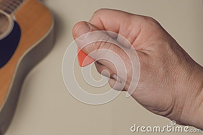 Man show how to correctly hold a guitar pick Stock Photo