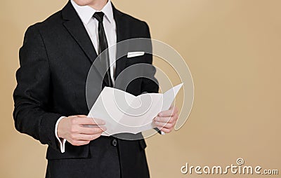 Man showing blank black flyer brochure. Read detailed booklet. L Stock Photo