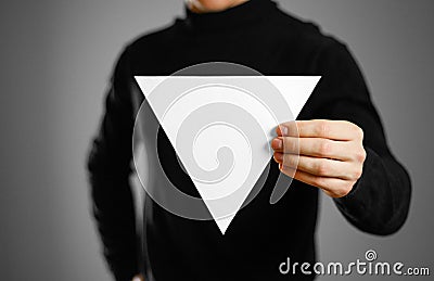 Man showing blank triangular white paper. Leaflet presentation. Stock Photo