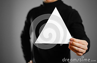 Man showing blank triangular white paper. Leaflet presentation. Stock Photo