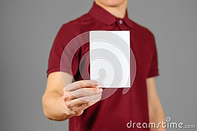 Man showing blank white flyer brochure booklet. Leaflet presentation Stock Photo