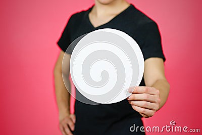 Man showing blank white rounded flyer brochure booklet. Leaflet Stock Photo