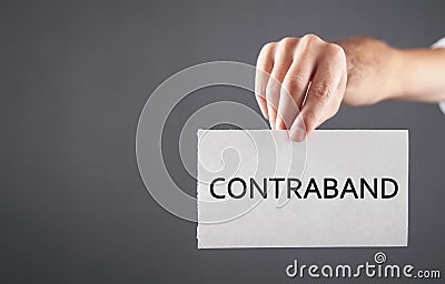 Man showing Contraband word on paper Stock Photo