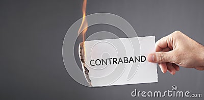 Man showing Contraband word on paper Stock Photo