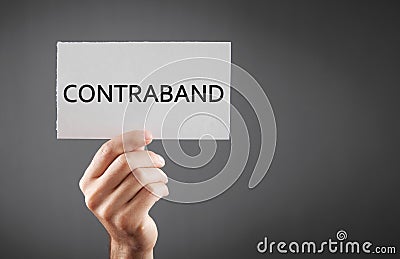 Man showing Contraband word on paper Stock Photo