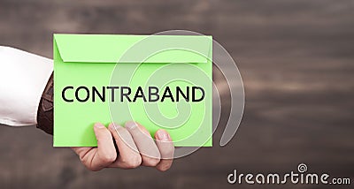 Man showing Contraband word on paper Stock Photo