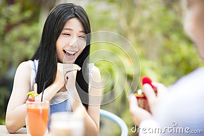 Man showing engagement ring diamond to girlfriend Stock Photo