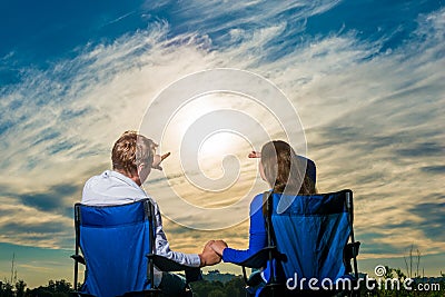 Man showing finger girl something in sky Stock Photo