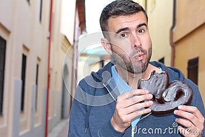 Man showing gluttony while eating dessert Stock Photo