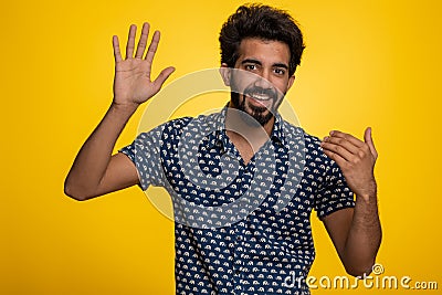 Man showing inviting gesture with hands, ask to join, beckoning to coming, gesturing hello goodbye Stock Photo