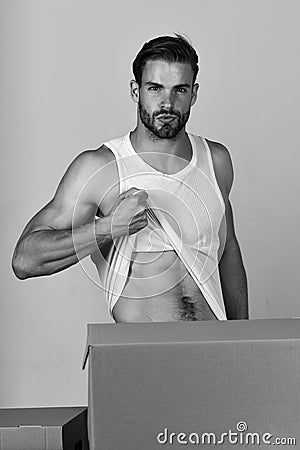 Man showing torso among cardboard boxes Stock Photo