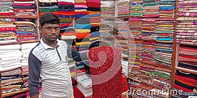 Man showing traditional sari to the store Editorial Stock Photo