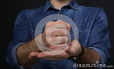Man showing word CRUCIFY in sign language on black background Stock Photo