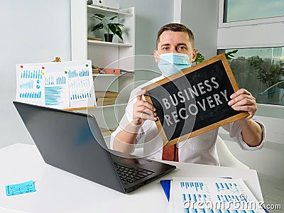 Man shows board with sign Business recovery and continuity plan. Stock Photo