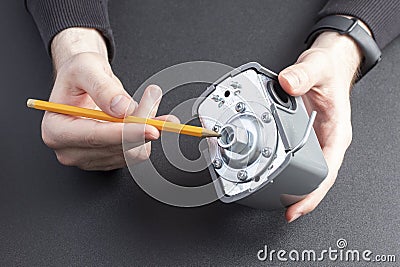 Man shows the pressure switch for pressure regulation in pumping station. Stock Photo