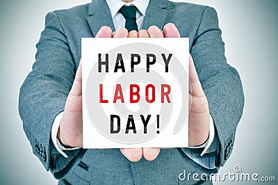 Man shows a signboard with the text happy labor day Stock Photo