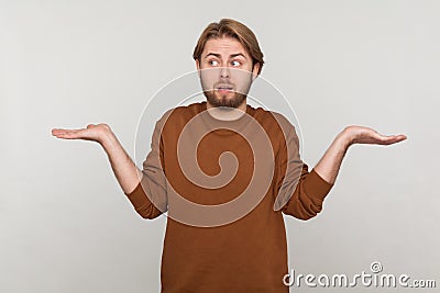 Man shrugging shoulders as doesn't know answer, cant make decision, being uncertain, not sure. Stock Photo