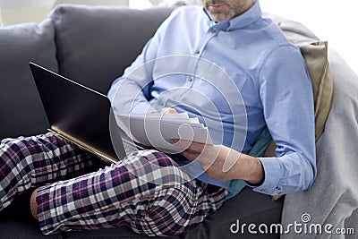 Man on sick leave working at home Stock Photo