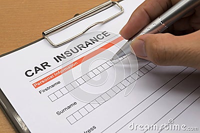 Man signing a car insurance policy Stock Photo