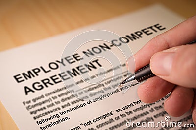 Man signing an employee Non-compete agreement Stock Photo