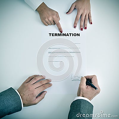Man signing a termination document Stock Photo