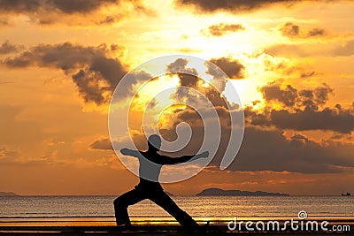 Man silhouette doing yoga exercise archer Stock Photo