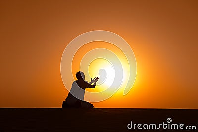 Man silhouette kneel and pray for help Stock Photo