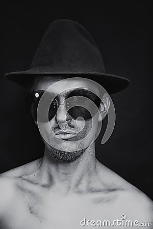 Man with silver make-up in hat and sunglasses Stock Photo