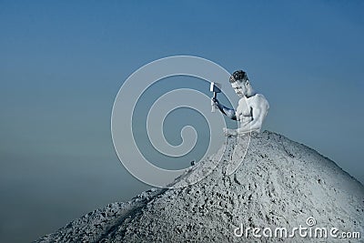 Man with silver skin saving himself from big mountain. Stock Photo