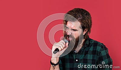 man singer love music. brutal man sing with microphone. vocal school. brutal and rock. bearded man wear checkered shirt Stock Photo