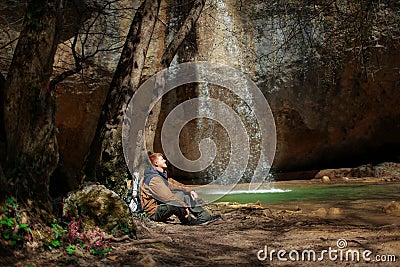 Man sits near Kozyrek waterfall in Crimea Stock Photo