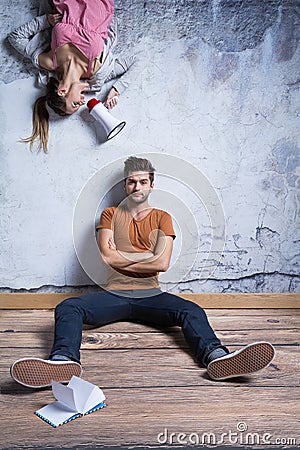 Man sitting against wall Stock Photo
