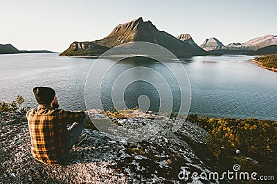 Man sitting alone enjoying sea and mountains view Stock Photo