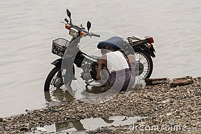 Man fixing a old motorbike Editorial Stock Photo