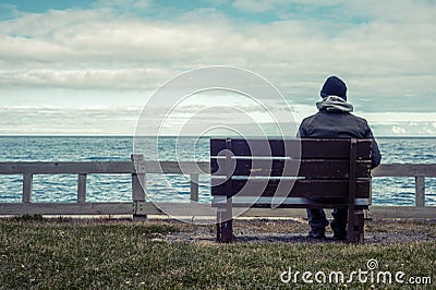 Man sitting on bench Stock Photo