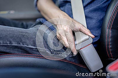 Man Sitting In Car Fastening Seat Belt, Safety belt safety first Stock Photo