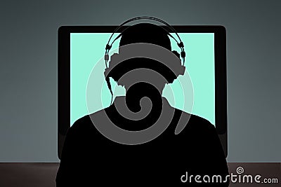 Man sitting at the desk in front of a computer with copy space for your text Stock Photo