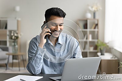 Man sitting at desk lead talk to client by phonecall Stock Photo