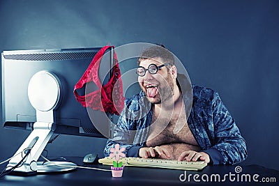 Man sitting at desk looking on computer screen Stock Photo