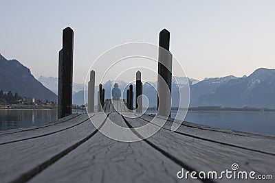 A man sitting footbridge over the water Stock Photo