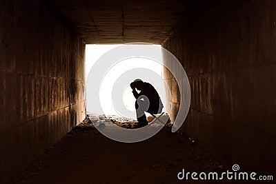 Man sitting looking upset Stock Photo