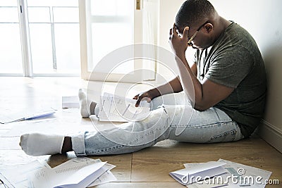 Man sitting and managing the debt Stock Photo