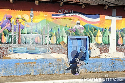 Man sitting near a mural at Ataco Editorial Stock Photo