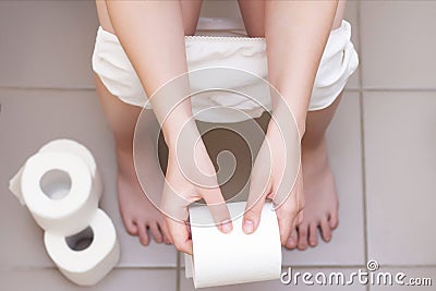 man is sitting on the toilet. Stock Photo