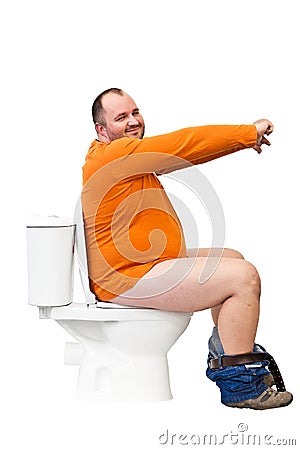 Man sitting on toilet with uplifted hands Stock Photo