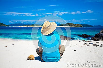 Man sitting on the tropical island beach Stock Photo