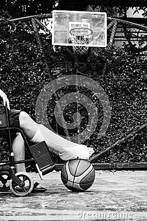 Man sitting on wheel chair with broken leg Stock Photo