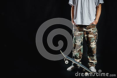 Man with skateboard on a black background Stock Photo